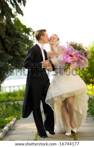 stock photo : Colorful wedding shot of bride and groom kissing