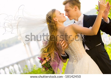 stock photo : Colorful wedding shot of bride and groom kissing