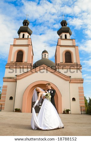 Beautiful bride and groom on  church background