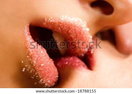 Closeup of pair girl mouths kissing