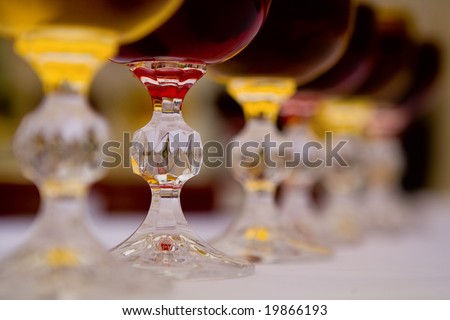 Row of wineglasses with red and yellow wine