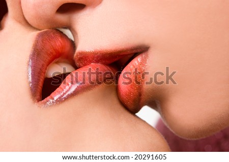 Closeup of pair girl mouths kissing