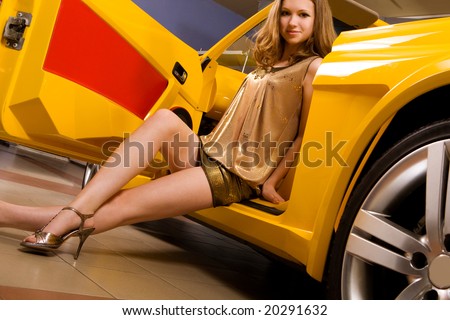 Beautiful woman with yellow sport car