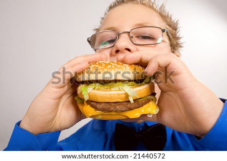 fat boy eating food. fat school oy eating