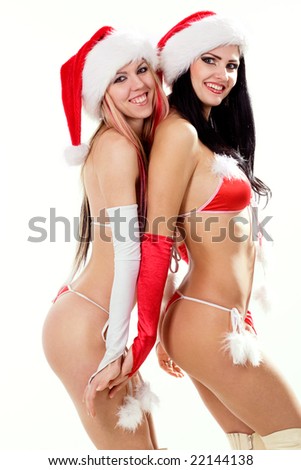 stock photo Two sexy playful girls in red bikini and christmas hats