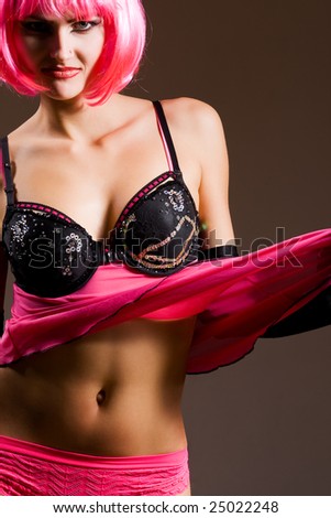 Attractive woman wearing black lingerie and magenta wig