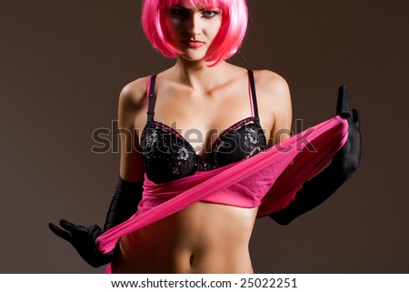 Attractive woman wearing black lingerie and magenta wig
