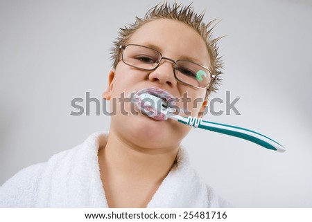 Funny young boy cleaning teeth