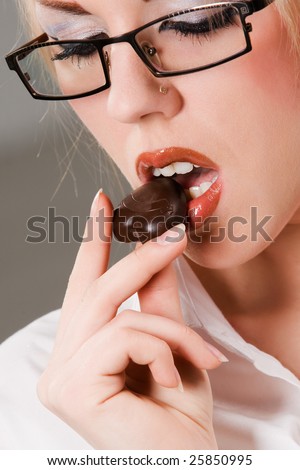 Pretty woman holding chocolate heart shaped candy
