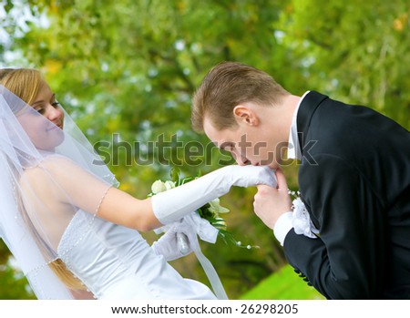 stock photo : Young groom kissing bride's hand