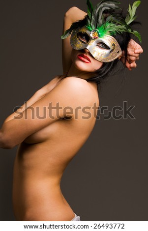 stock photo Beautiful naked brunette with carnival mask isolated