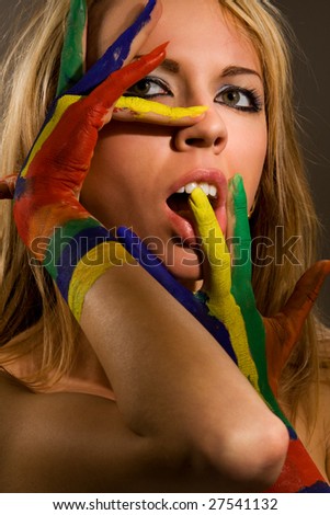 Pretty female model with hands painted rainbow style