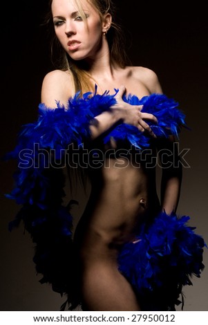 Sexy young naked woman with blue feathers scarf