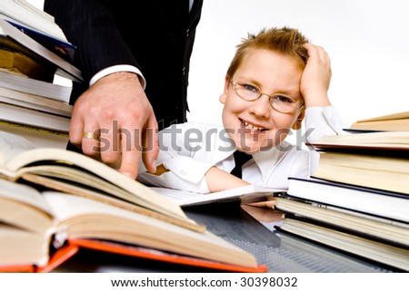 Man\'s hand pointing to school books, forcing boy to learn . Isolated