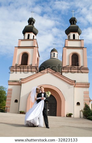 Beautiful bride and groom on  church background