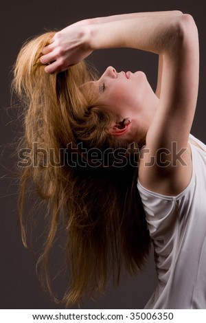 Young caucasian woman throwing head back