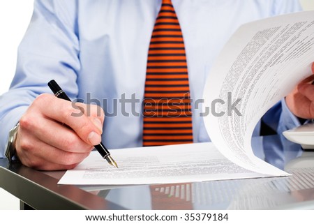 Businessman signing contract with pen