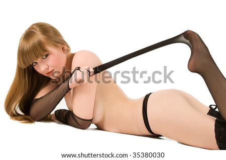stock photo Cute topless girl pulling fishnet stockings