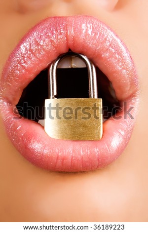 woman holding metal padlock  in her mouth