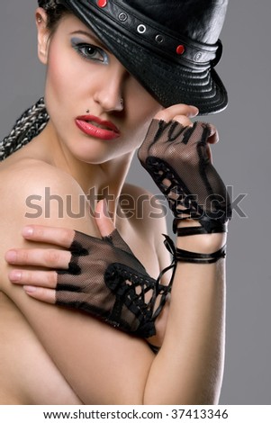 Beautiful topless model with hat and gloves portrait