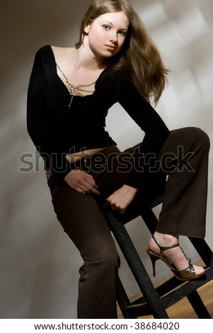 Young woman classic studio portrait with chair