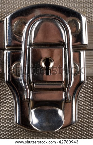 Shiny metal case lock closeup