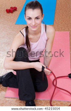 Pretty young woman with skipping rope