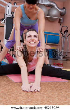 Happy young women exercising in sport club