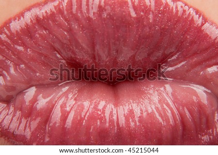 Shiny woman\'s lips bowing in kiss