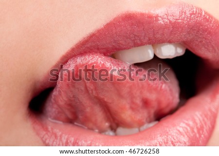 Woman\'s tongue seductively licking lips