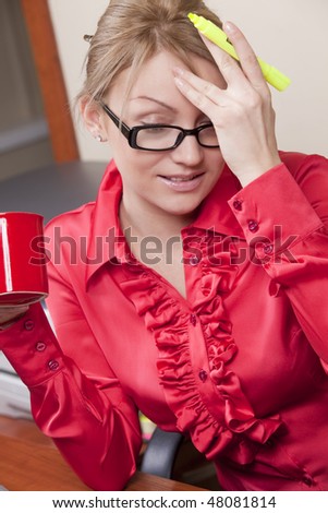 Attractive female manager with coffee cup thinks about the prosperous business