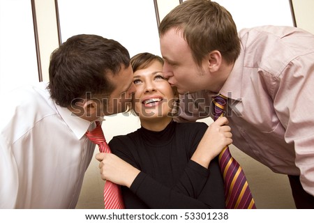 Two colleagues kissing  businesswoman and she pulling their ties