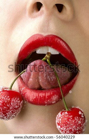 Young woman's mouth with red cherries covered with sugar