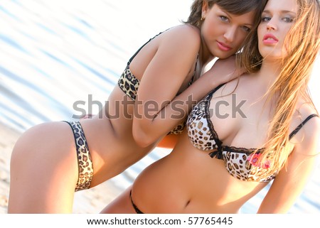 stock photo Two pretty young girls ono the beach