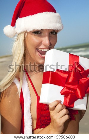 Happy girl in Santa Clause suit with gift box