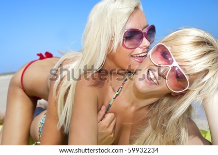stock photo : Pretty girl has a fun with her girlfriend on the beach