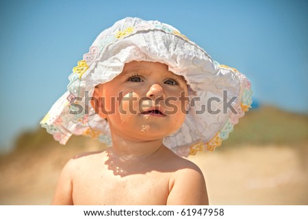 stock photo Fanny infant girl in sun with sun hat