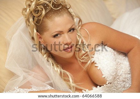 Portrait of beautiful bride with blond hair wearing luxurious wedding dress
