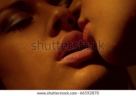 Closeup of pair girls mouths kissing - stock photo