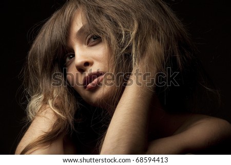 Portrait of pretty young woman isolated on dark background