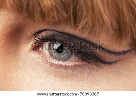 Close-up of woman eye with ceremonial bright make-up