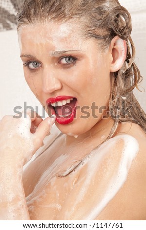 Portrait of young sexy woman with soap foam