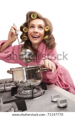 stock photo Shot of sexy housewife in pink dressing gown tasting dish in