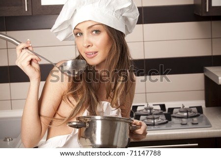 stock photo Portrait of sexy housewife tasting dish in kitchen room