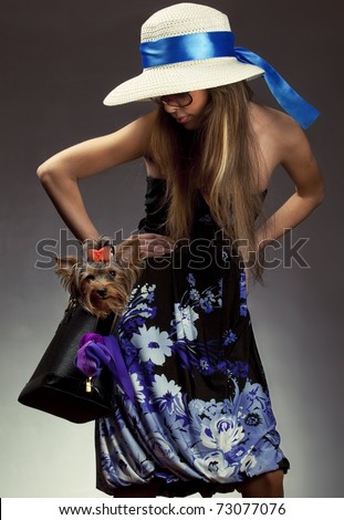 Shot of young glamor woman with Yorkshire Terrier dog in her bag
