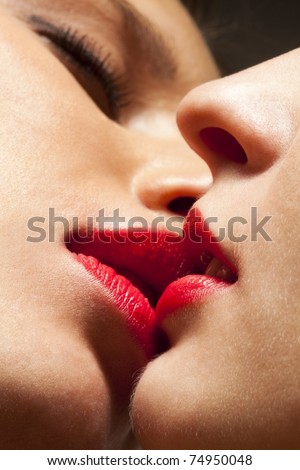 Closeup of pair women mouths kissing