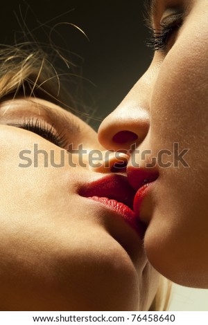 Closeup of pair women kissing