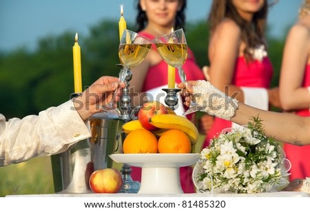 stock photo Bride and groom clinking glasses of champagne at wedding table