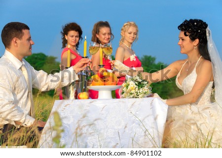 stock photo Bride and groom clinking glasses of champagne at wedding table