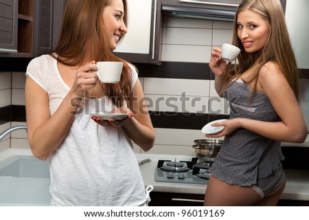 Beautiful young sexy women drinks hot coffee at home